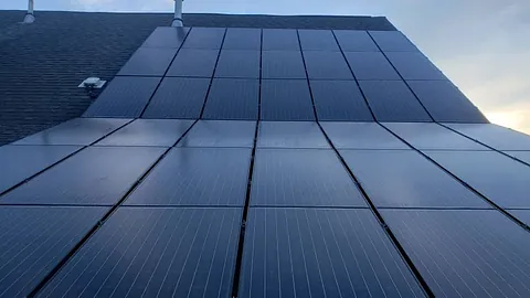 Home with an array of solar panels